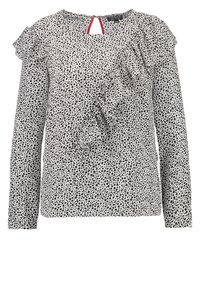 Blusa a maniche lunghe bianca con macchie nere, dotata di un dettaglio arricciato e un'apertura a forma di chiave sulla schiena con un'accento rosso. Tessuto leggero.