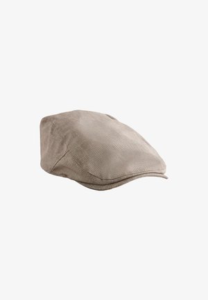 Jasnobrązowa czapka typu „flat cap” wykonana z teksturowanej tkaniny z widocznym przeszyciem i małym daszkiem z przodu.