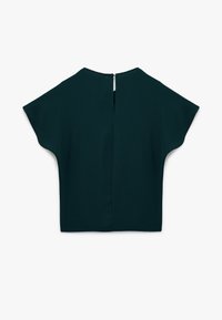 Mørkegrøn bluse med korte, brede ærmer, en nøglehulsryg med en lille lynlås og et glat, tekstureret stof.