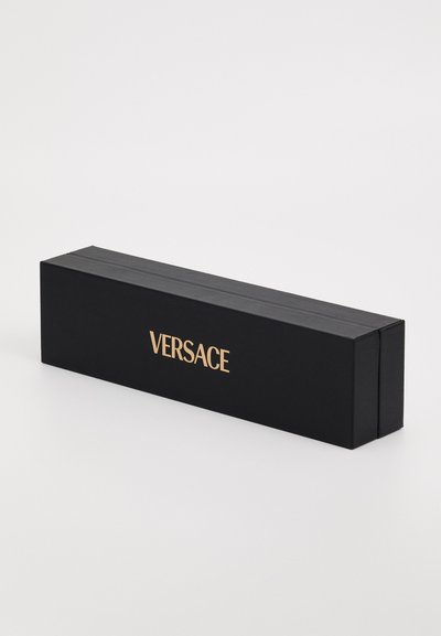 Musta suorakulmainen laatikko, jossa on teksturoitu pinta, ja etupuolella on voimakkaasti esillä kultainen "VERSACE"-logo. Suljettu läpällä.