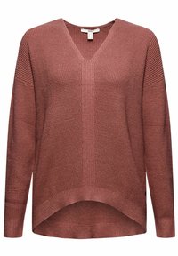 Pull en tricot rose avec un décolleté en V, coupe ample et manches longues. Présente un tissu texturé et un ourlet légèrement courbé en bas.
