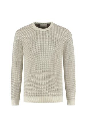Ljust beige stickad tröja med ett texturerat mönster, rund halsringning och långa ärmar. Ribbad mudd och fåll förbättrar designen.