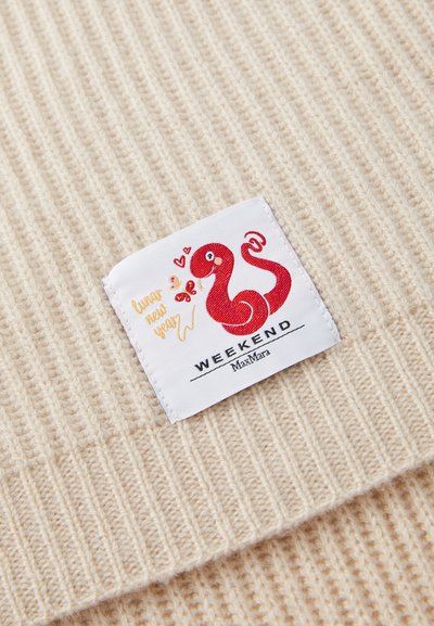 Beige ribbed fabric with a white label featuring a red snake graphic and "Lunar New Year" text, under the "WEEKEND MaxMara" brand.
