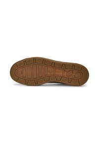Semelle d'une chaussure en caoutchouc marron avec différents motifs texturés et le logo Puma embossé au centre.