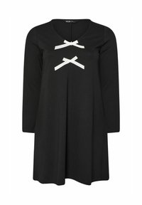 Schwarzes langärmeliges Kleid mit V-Ausschnitt; verfügt über zwei weiße Ripsbandakzente auf der Vorderseite und weitet sich leicht von der Taille. Weicher Stoff.