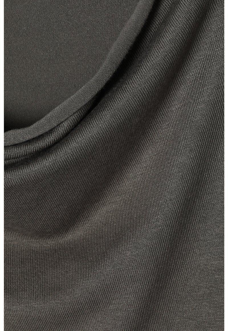 Tessuto a coste di un grigio scuro con una consistenza morbida, caratterizzato da pieghe delicate e una leggera lucentezza. Il materiale è elastico e liscio.