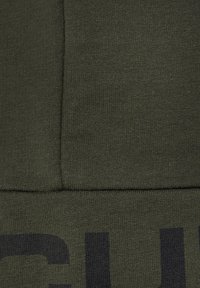 Olive green sweatshirt fabric with a textured knit finish. Features a bold black print along the lower section and a seam detail at the center.
