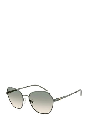Gafas de sol metálicas grises con una forma hexagonal única. Lentes de degradé, patillas delgadas y almohadillas nasales transparentes. Acabado en dorado en la patilla.