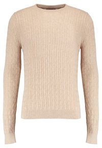 Beige ribbstickad tröja med långa ärmar, rund halsringning och strukturerat mönster. Mjukt tyg och figurnära design.