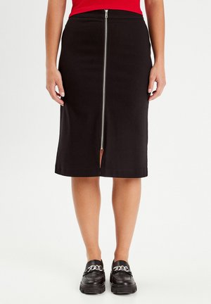 Black knee-length skirt made of stretchy fabric with a central zipper from hem to waist. Features a front slit and smooth texture.