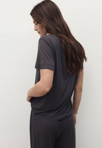 Gray short-sleeve top in a soft, lightweight fabric, featuring a relaxed fit. The back view shows subtle draping and shoulder seam details.