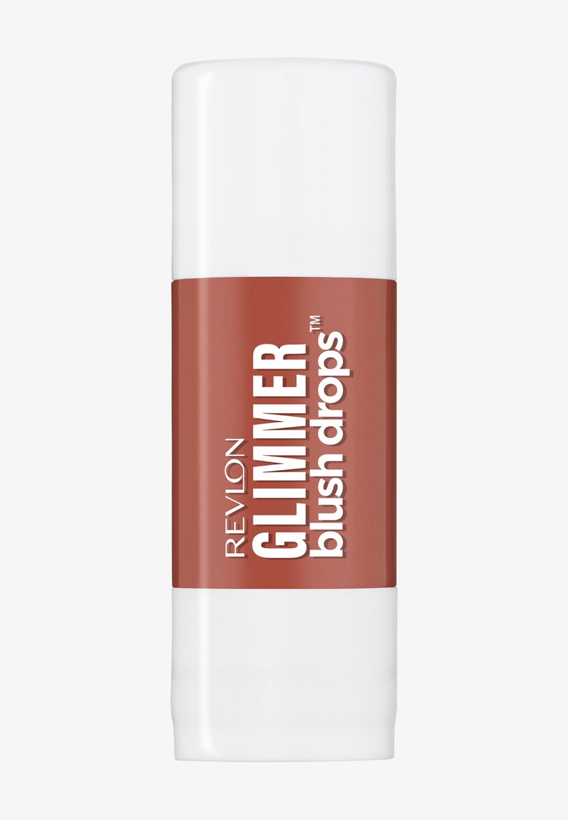 Revlon Glimmer blush drops in un contenitore rettangolare bianco con etichetta marrone e testo bianco in grassetto su uno sfondo chiaro semplice.