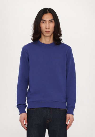 Sudadera de cuello redondo morada hecha de una mezcla de algodón; presenta puños y dobladillo de canalé, un detalle logo minimalista en el pecho y un ajuste holgado.