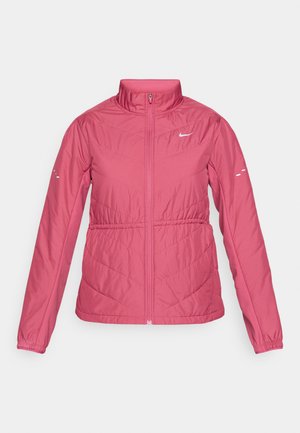 Růžová prošívaná bunda s vysokým límcem, zipovým zapínáním, elastickými manžetami a bílým logem Nike. Na přední straně má diagonální prošívaný vzor.