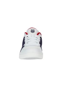 K-Swiss sneakers feature a white leather upper with navy stripes, red accents on the collar, and a logo on the tongue. Lace-up closure.