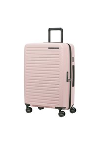 Pink hard-shell suitcase with textured ribbed surface, retractable black handle, and four black wheels for easy mobility.