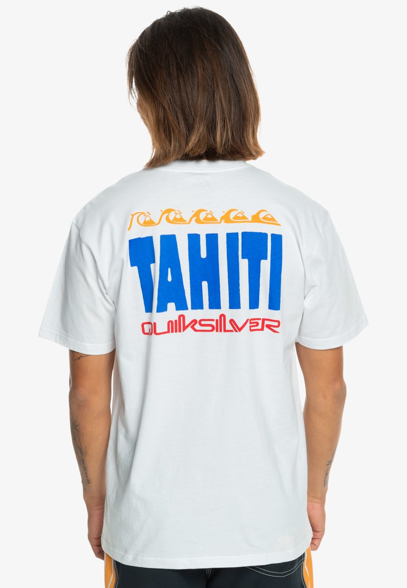 White cotton t-shirt featuring a large blue "TAHITI" graphic and red "Quiksilver" text on the back, accented with orange wave patterns.