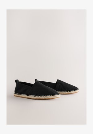 Espadrillas in tessuto nero con superficie strutturata e design senza lacci. Caratterizzate da suola in giunco intrecciato e cuciture chiare a contrasto lungo il bordo.