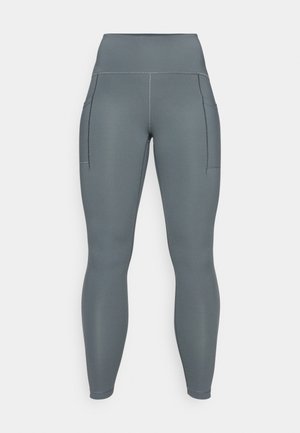 Leggings gris taille haute avec deux poches latérales, fabriqués en tissu extensible, avec des coutures plates et une texture lisse.