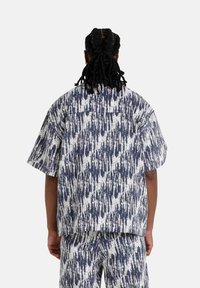 Korte mouwen shirt in marineblauw en wit, met een gestructureerd, abstract patroon. Gemaakt van lichtgewicht stof met een ontspannen pasvorm.