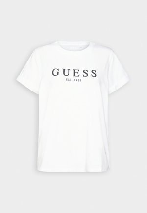 T-shirt en coton blanc avec un col rond, des manches courtes et le texte noir "GUESS EST. 1981" centré sur le devant. Design simple.