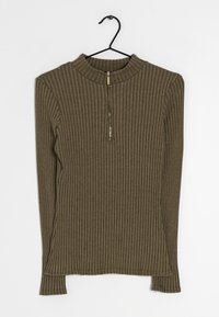 Maglione lungo a maniche lunghe color verde oliva a coste con colletto alto e zip a metà. Tessuto morbido, design aderente con spacchi laterali all'orlo.