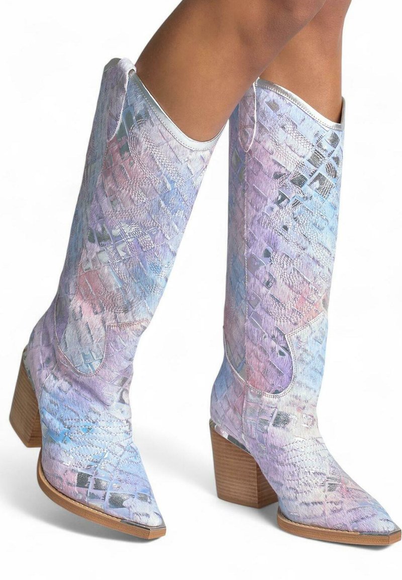 Botas de vaquera coloridas y brillantes que presentan un patrón texturizado, punta afilada y tacón apilado. Los tonos de lavanda, rosa y plata son predominantes.