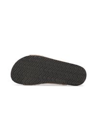 Semelle de chaussure en caoutchouc noir avec un motif de bande en vagues, bords beiges et zone de renforcement au niveau des orteils. Surface texturée pour une adhérence et une durabilité accrues.
