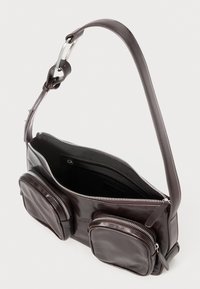 Brown leather bag with a long strap, featuring two front zippered pockets, a spacious main compartment, and a sleek, smooth texture.