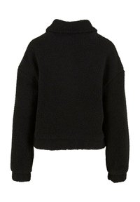 Zwarte fleece pullover met een zachte, gestructureerde buitenkant. Kenmerkt zich door een opstaande kraag en losse mouwen, met een cropped ontwerp.