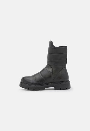 Black mid-calf leather boot with padded upper, round toe, thick sole with deep treads, and low heel, shown from the outer side.
