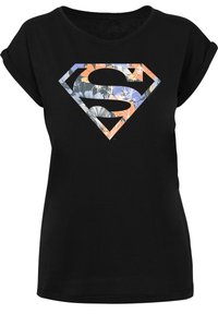 Black t-shirt with short rolled sleeves featuring a colorful floral-patterned Superman logo centered on the front.