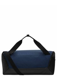 Sac de sport bleu marine en tissu texturé, avec des accents synthétiques noirs, des poignées doubles et un compartiment zippé à une extrémité.