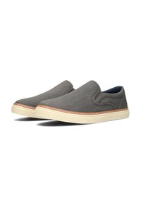 Grijze canvas instapschoenen met beige rubberen zolen, voorzien van gestikte details en een gladde binnenvoering. Geen veters, minimalistisch ontwerp.
