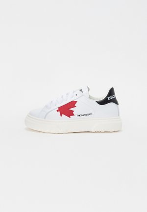 White leather sneaker with red maple leaf design. Black heel accent features "DSQUARED2." Thick white sole, casual lace-up style.