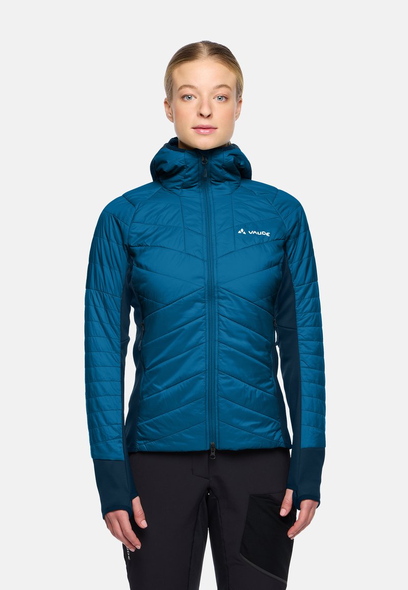 Teal geïsoleerde jas met capuchon, featuring een chevron-gestikte ontwerp en contrasterende donkerblauwe mouwen. Voorzien van ritszakken en duimhole.