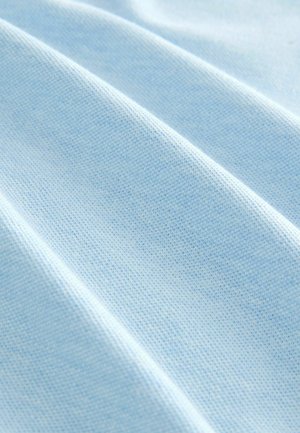 Light blue fabric with a textured weave, featuring soft, smooth folds and a subtle pattern. Suitable for clothing or textile applications.