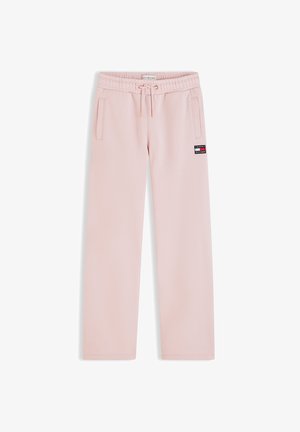 Pantalon décontracté rose clair avec taille élastique, cordon de serrage, poches latérales et petite étiquette avec le logo Tommy Hilfiger sur la cuisse droite.