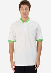 Polo bianco con colletto verde e accenti verdi sulle maniche. Presenta un piccolo logo verde sul petto. Realizzato in tessuto leggero.