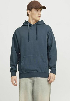 Navy blue hooded sweatshirt made of cotton blend, featuring a kangaroo pocket, drawstrings, and ribbed cuffs and hem. Worn with light jeans.