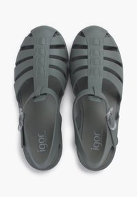 Gray rubber sandals with an open design, featuring slotted straps and a plastic buckle. The insoles display the brand name "igor."