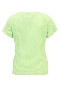 Light green textured top with a waffle pattern, short sleeves, and a relaxed fit. Back view, highlighting the material's subtle design.