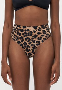 High-waisted bikini bottom in leopard print with a tan base and black spots, made from smooth, stretchy material. No visible hardware.