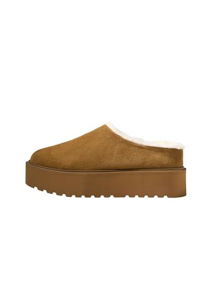 Brown suede slip-on shoe with thick rubber sole and white fleece lining around the opening, shown from the side on a white background.