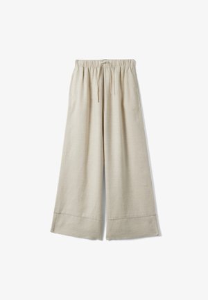 Beige wijde broek met elastische tailleband en trekkoord, voorzien van zijzakken en brede zoom.
