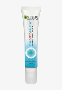 Garnier Pure Active SOS Anti-Spots Stick in a clear tube with a blue gradient. Features a twist-up applicator and labeled "Dermatologically Tested."