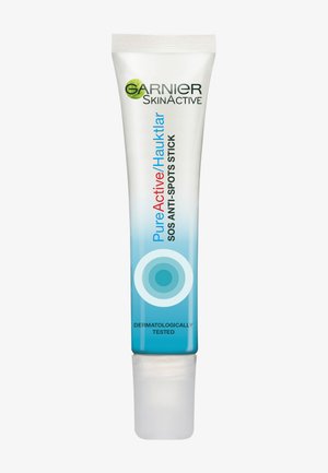 Stick anti-macchie Garnier Pure Active SOS in un tubo trasparente con una gradazione di blu. Presenta un applicatore a rotazione ed è contrassegnato con "Testato dermatologicamente".