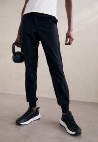Casall COMFORT PANTS - Treniņtērpa apakšdaļas - black