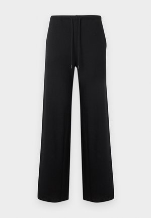 Zwarte wijde broek met elastische tailleband en trekkoord, plat uitgespreid op een lichte achtergrond.