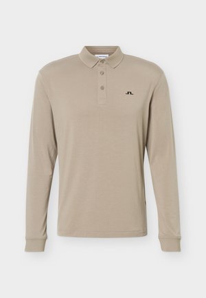 Beige long-sleeve polo shirt with three buttons and small black logo on left chest, featuring a classic collar and cuffed sleeves.